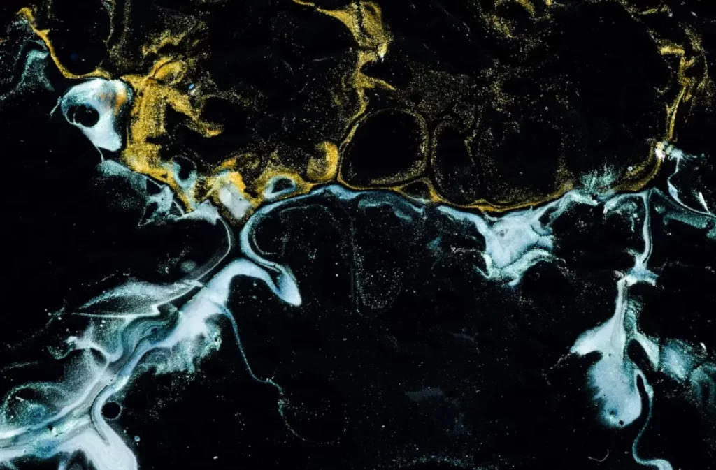 Abstract black marble with gold and white fluid textures.