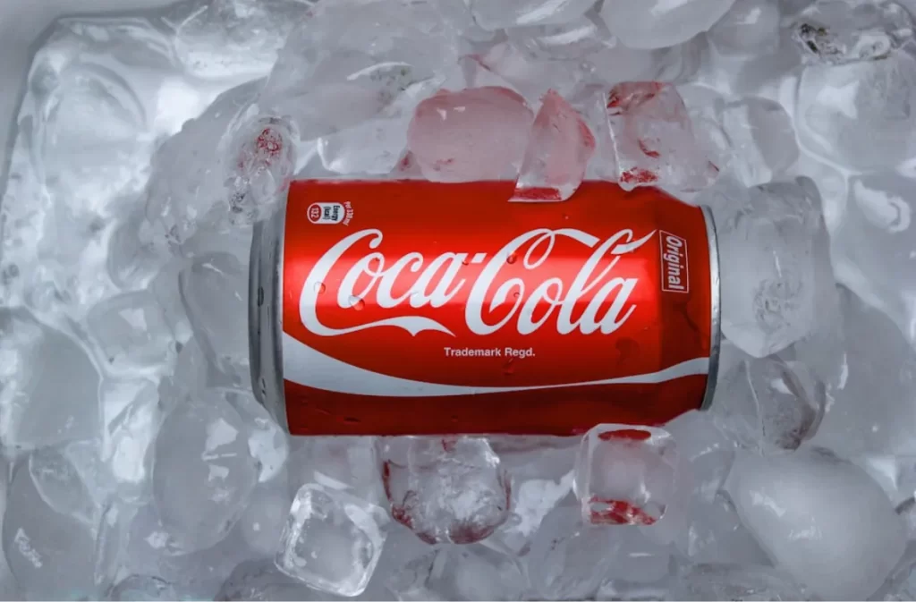 Coca-Cola can on ice highlighting long drink nutrition facts.